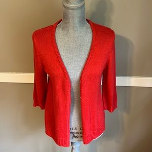 Red/orange sweater. PM.